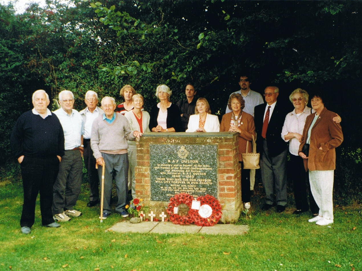 Fortress_HB799_Tom_Tate_(with_stick)_and_family_members_of_those_murdered_in_Huchenfeld_March_1945_at_the_RAF_Oulton_Memorial